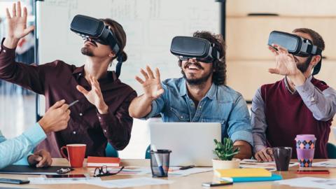 Stock image of people testing VR headsets