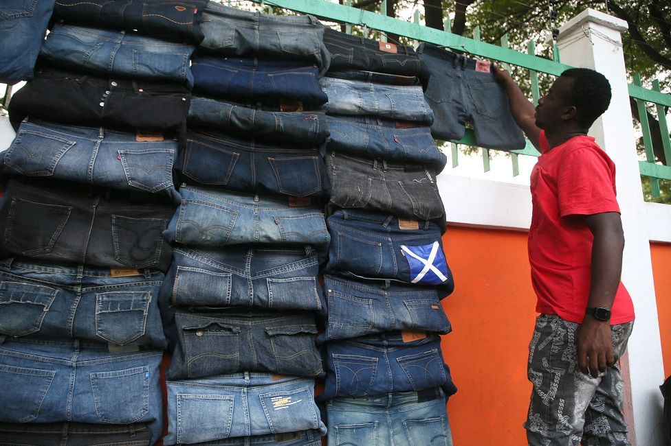 A vendor displays second-hand clothes on a street in Abidjan.