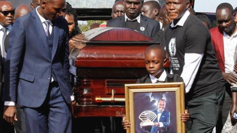Pallbearers carry the coffin of Kenya's marathon world record holder Kelvin Kiptum, who died in a road accident, during his funeral service at Chepkorio showground
