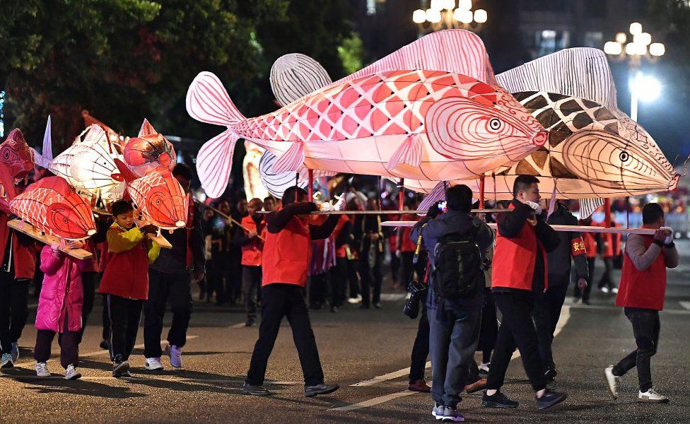 Folk artists and children parade with fish lanterns in Sanming, Fujian Province, China