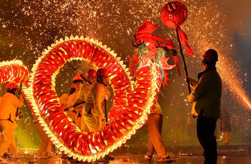 People perform a dragon dance amid fireworks in Taijiang County, Qiandongnan Miao and Dong Autonomous Prefecture, Guizhou Province of China