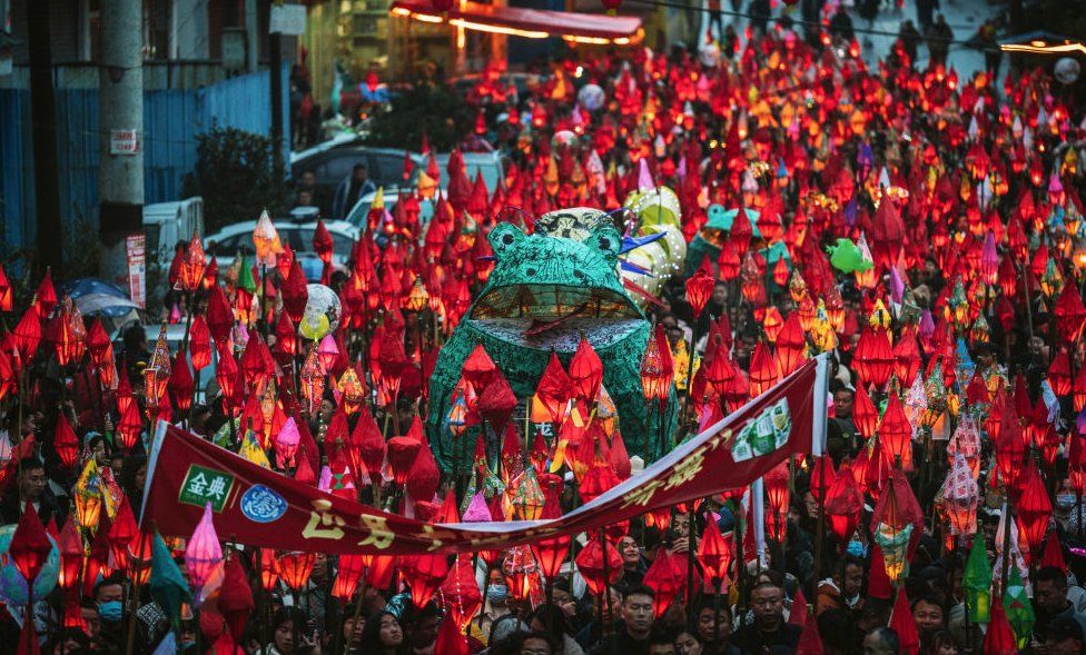 People parade with frog-shaped lanterns during the Qima Festival on February 23, 2024 in Nanchong, Sichuan Province of China. Local people have the tradition to send frog lanterns to the river bank ahead of the Lantern Festival to wish for good health and safety