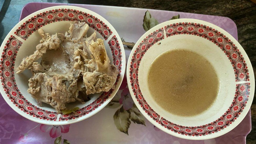 Two bowls of soup and chicken side by side