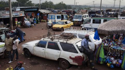 Cars and buses at a public transport station in Bamako